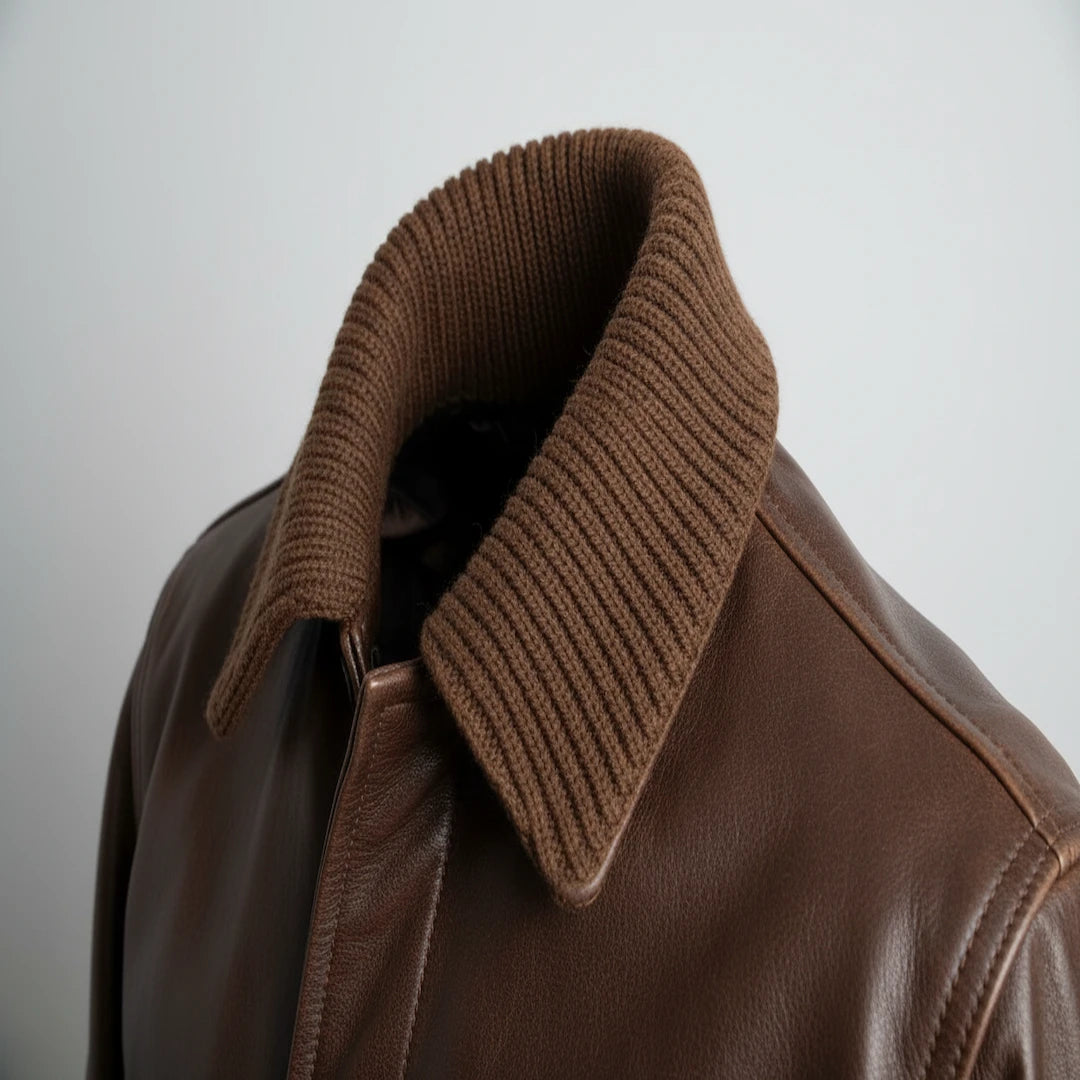 Brown leather jacket with a ribbed collar on a light gray background