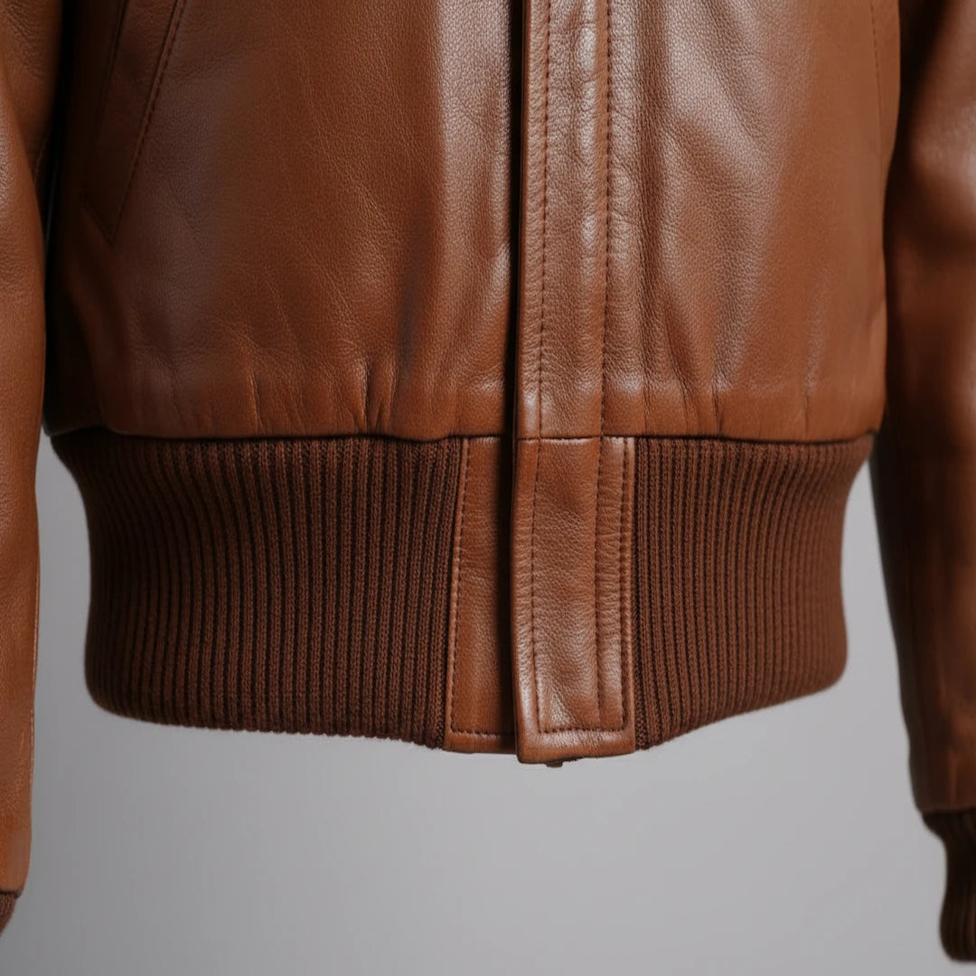 Close-up of a brown leather jacket on a gray background